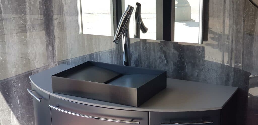 Featured image showing a unique sink from Mila International mounted on a modern cabinet with a single handle faucet