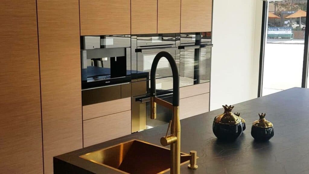 Featured image showing Mila International's Gold Kitchen Sink with a modern faucet in a minimal modern kitchen.