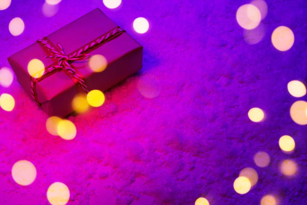 Featured image showing a purple wrapped gift and holiday lights.