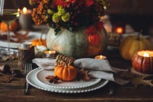 Featured image showing an elegant Thanksgiving Table with pumpkins and candles.