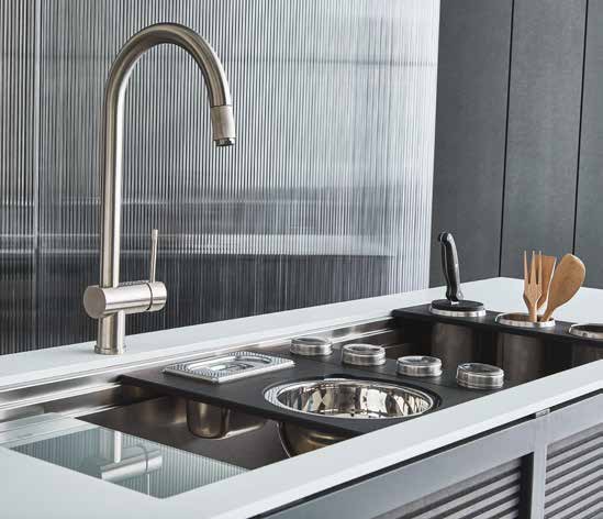 Featured image showing a Foster undermount stainless steel sink, faucet and workstation in a commercial grade kitchen