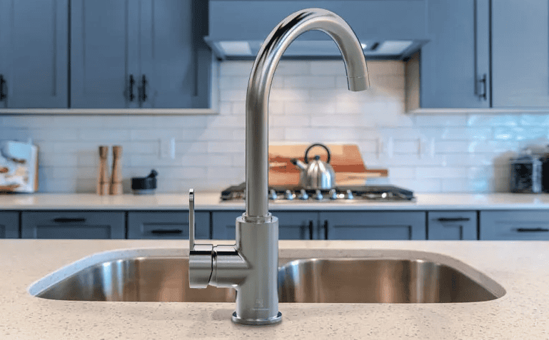 Inline image showing a Wasserwerk Faucet in a modern kitchen with blue steel cabinets.